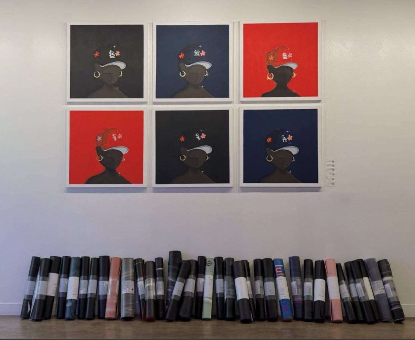 Art pieces displayed in a gallery setting, representing the Vault Gallerie collaboration