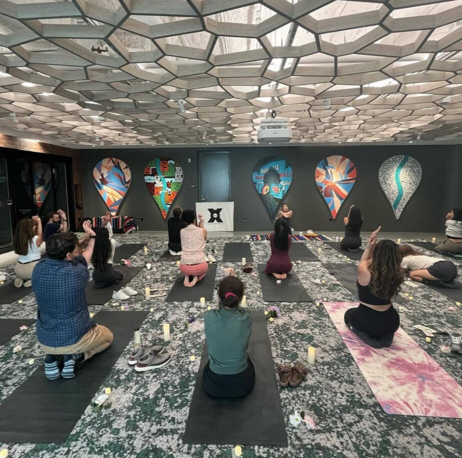 Professionals in an office setting participating in a wellness reset with Google