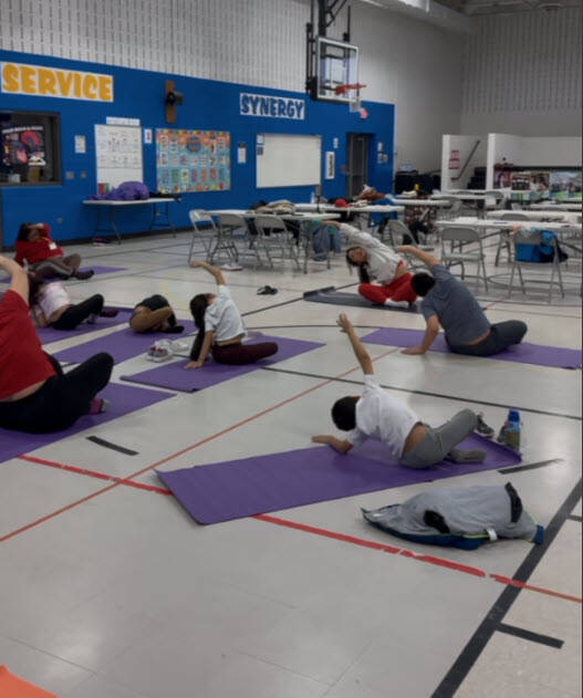 Parents and children doing yoga together at Mechanics Grove Elementary