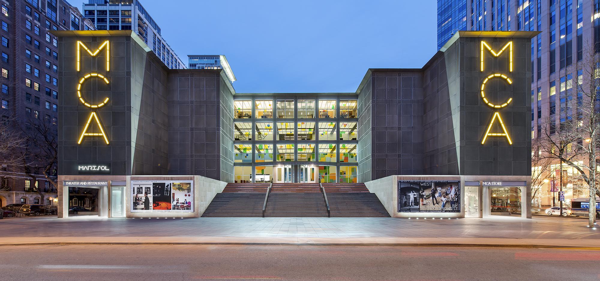 MCA Chicago facade at dusk with the museum entrance and illuminated MCA signage