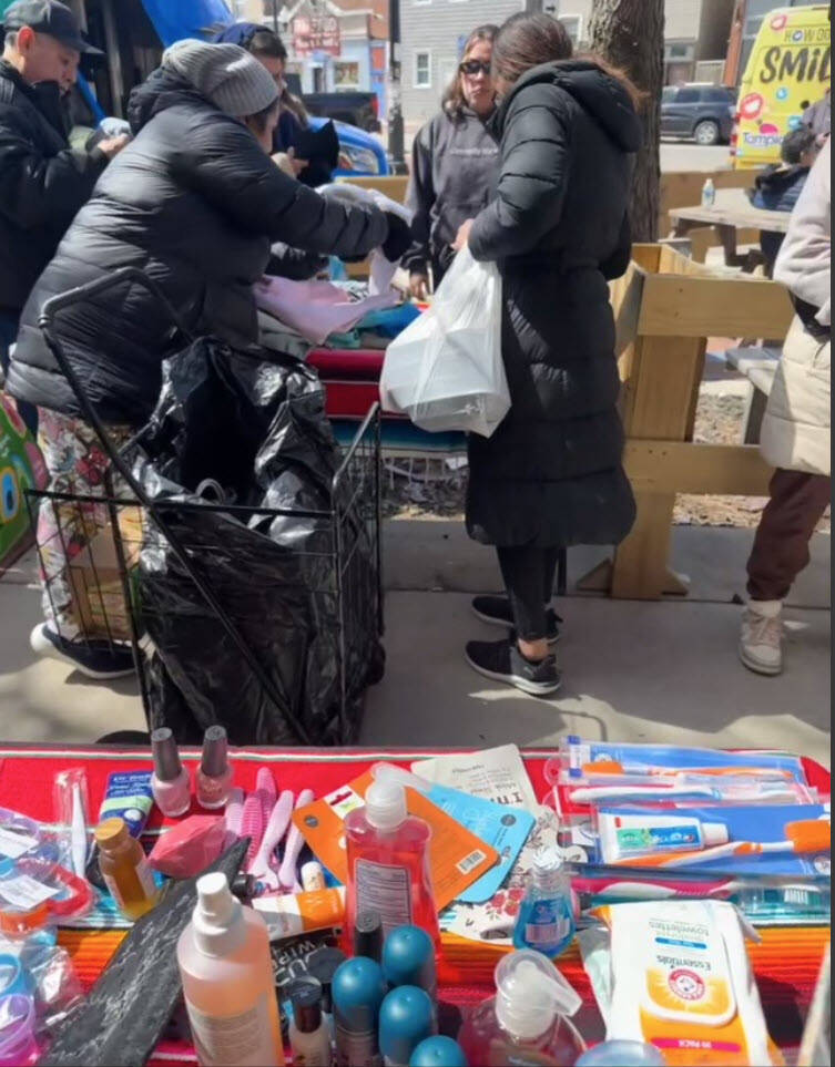 A community member receiving a bag of groceries