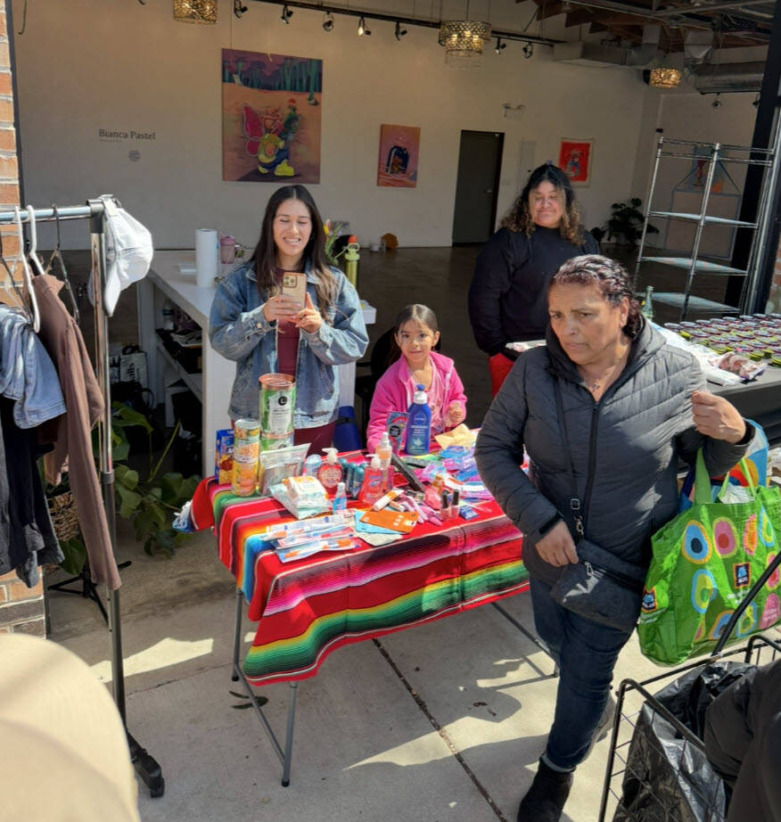 Volunteers smiling together during a donation drive
